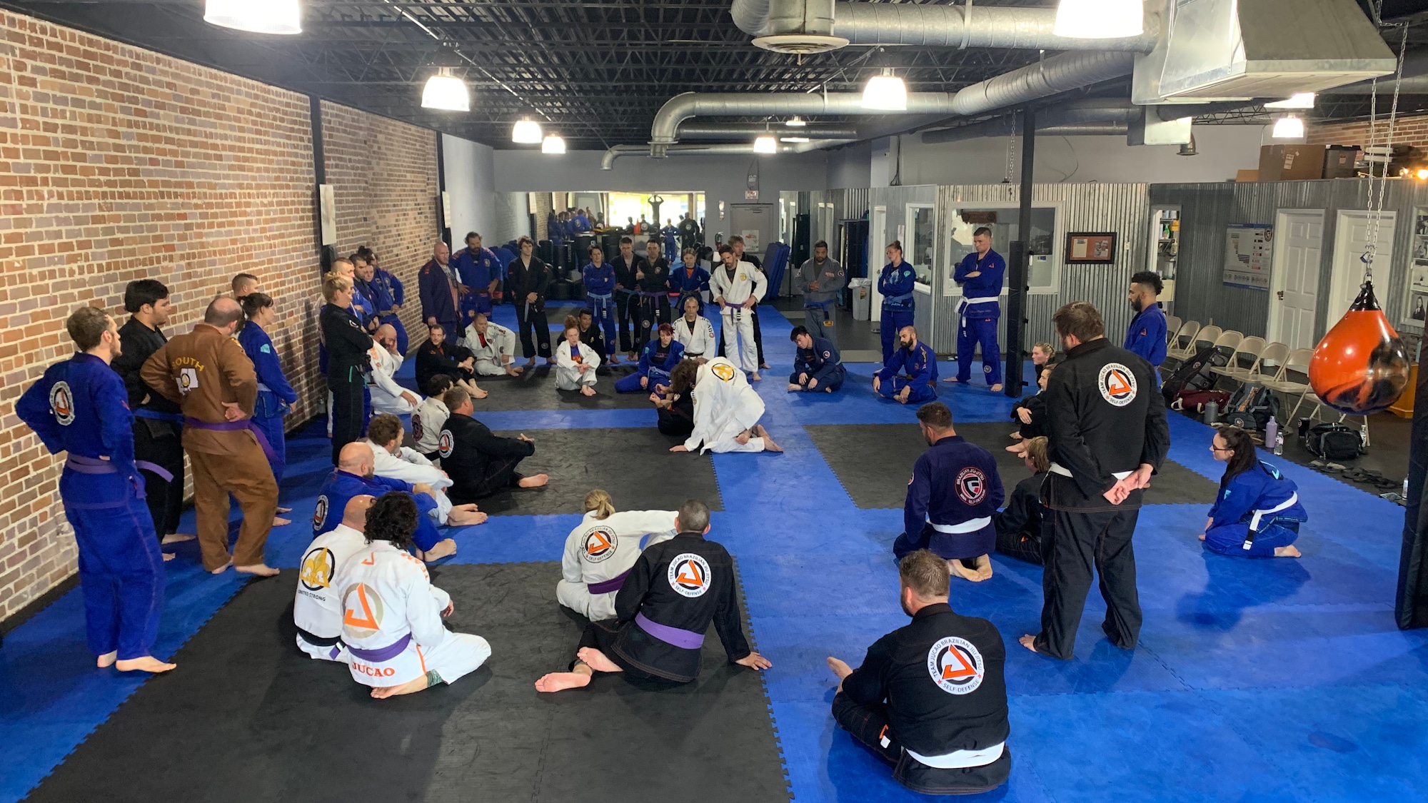 Gracie United students gathered on the mat for instruction